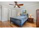 Bedroom featuring hardwood floors, a ceiling fan, and bright windows overlooking the exterior at 1107 S 2Nd St, Smithfield, NC 27577