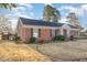 Side view of a beautiful brick home with classic blue shutters and manicured landscaping at 1107 S 2Nd St, Smithfield, NC 27577