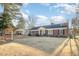 Charming brick home with blue shutters, a well-manicured lawn, and a detached garage on a sunny day at 1107 S 2Nd St, Smithfield, NC 27577