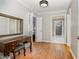 Hallway with hardwood floors, a vintage desk, and doorways leading to other rooms at 1107 S 2Nd St, Smithfield, NC 27577