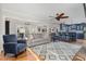 Open-concept living room features stylish furnishings and hardwood floors adjacent to the updated kitchen at 1107 S 2Nd St, Smithfield, NC 27577
