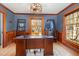 Sophisticated office with a large wooden desk, wood trim, and natural light, providing a workspace at 1107 S 2Nd St, Smithfield, NC 27577