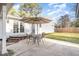 Outdoor patio with table, chairs, and umbrella for entertaining, complemented by double doors to the home at 1107 S 2Nd St, Smithfield, NC 27577