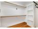 Bright walk-in closet with built-in shelving and wood flooring offering storage space at 1107 S 2Nd St, Smithfield, NC 27577