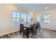 Well-lit dining room with a modern table, seating for four, and large windows at 124 N Finley Landing Parkway # 4, Smithfield, NC 27577