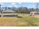 Spacious backyard featuring a fire pit, storage shed, and fenced area at 1304 Nc 96 Hwy S, Zebulon, NC 27597