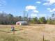 Large barn and fenced dog area on a sunny day at 1304 Nc 96 Hwy S, Zebulon, NC 27597