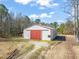 Exterior view of barn with large red doors, ideal for storage or livestock at 1304 Nc 96 Hwy S, Zebulon, NC 27597