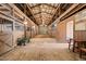 Barn interior showcasing stalls, wooden beams, and ample space for animals at 1304 Nc 96 Hwy S, Zebulon, NC 27597