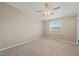 Cozy bedroom features neutral carpeting, a bright window, and a modern ceiling fan at 1304 Nc 96 Hwy S, Zebulon, NC 27597