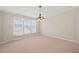Neutral dining room is illuminated by a modern light fixture and natural light from the window at 1304 Nc 96 Hwy S, Zebulon, NC 27597