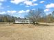 View of a well-kept single story home surrounded by trees at 1304 Nc 96 Hwy S, Zebulon, NC 27597