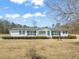 Charming single-story home featuring a well-maintained lawn, white siding, and black shutters at 1304 Nc 96 Hwy S, Zebulon, NC 27597