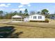 Exterior view featuring a covered carport, gravel driveway, and well-maintained lawn at 1304 Nc 96 Hwy S, Zebulon, NC 27597