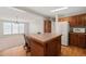 Kitchen with adjacent living area, island and wood cabinetry at 1304 Nc 96 Hwy S, Zebulon, NC 27597