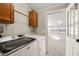 Functional laundry room with modern washer and dryer, storage cabinets, and access to sunroom at 1304 Nc 96 Hwy S, Zebulon, NC 27597