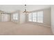 Neutral living room is illuminated by a modern light fixture and natural light from the window at 1304 Nc 96 Hwy S, Zebulon, NC 27597