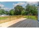 Spacious wooden back deck surrounded by lush greenery, perfect for outdoor relaxation at 136 E End Ave # 4, Durham, NC 27703