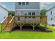 Backyard view of the home's deck and the green lawn surrounding the property at 136 E End Ave # 4, Durham, NC 27703