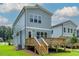 A view of the backyard deck, a manicured lawn, and the home's exterior at 136 E End Ave # 4, Durham, NC 27703
