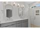 Modern bathroom boasts double sinks, sleek gray cabinets, and a walk-in shower with white subway tile at 136 E End Ave # 4, Durham, NC 27703