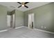 Neutral-toned bedroom featuring plush gray carpet, ample natural light, and en-suite bathroom access at 136 E End Ave # 4, Durham, NC 27703