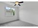 Clean, bright bedroom offers cozy gray carpet, natural light from a large window and clean white walls at 136 E End Ave # 4, Durham, NC 27703