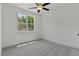 Clean, bright bedroom features plush carpet, large window, and neutral color palette at 136 E End Ave # 4, Durham, NC 27703