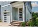Inviting entrance features a stylish gray door with a brick-paved step and an attached one-car garage at 136 E End Ave # 4, Durham, NC 27703