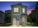 Beautiful two-story home at twilight with a modern garage, well-lit porch, and stylish design at 136 E End Ave # 4, Durham, NC 27703