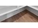 Close-up of hardwood flooring and white baseboards at 136 E End Ave # 4, Durham, NC 27703