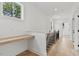 Bright hallway with hardwood floors, natural lighting, and built-in desk at 136 E End Ave # 4, Durham, NC 27703