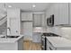 Modern kitchen featuring stainless steel appliances, sleek gray cabinets, and stylish backsplash at 136 E End Ave # 4, Durham, NC 27703