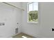 Bright laundry room featuring tile floors, a window with a view, and washer-dryer hookups at 136 E End Ave # 4, Durham, NC 27703