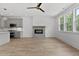 Bright living room featuring hardwood floors, a cozy fireplace, and an open kitchen concept at 136 E End Ave # 4, Durham, NC 27703