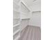 Large walk-in closet featuring built-in shelving and rods providing ample storage at 136 E End Ave # 4, Durham, NC 27703