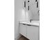 A modern bathroom features a new vanity, a white countertop and contemporary, hanging light fixtures at 140 E End Ave # 2, Durham, NC 27703