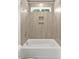 A modern bathroom features gray tile in the shower, a new tub, and a shower niche at 140 E End Ave # 2, Durham, NC 27703