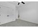 A bedroom features gray carpet, a ceiling fan and double doors that lead to the hallway at 140 E End Ave # 2, Durham, NC 27703