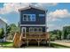 A modern two-story home with a dark exterior, white trim, and a wooden back deck at 140 E End Ave # 2, Durham, NC 27703