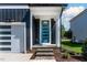Contemporary home with a blue front door, white garage door, and well-manicured landscaping at 140 E End Ave # 2, Durham, NC 27703