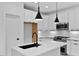 Bright kitchen with island, black fixtures, and stainless appliances at 140 E End Ave # 2, Durham, NC 27703