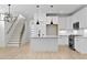 Modern, all-white kitchen with updated appliances, large island, and stylish pendant lighting at 140 E End Ave # 2, Durham, NC 27703