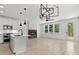 Bright, open living space with a fireplace, modern lighting, light wood floors, and access to a deck at 140 E End Ave # 2, Durham, NC 27703