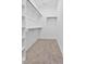 Spacious walk-in closet with built-in shelving and clothes racks at 140 E End Ave # 2, Durham, NC 27703