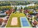 Aerial view of community tennis and sand volleyball courts along the beautiful lake at 1400 Gathering Park Cir # 202, Cary, NC 27519