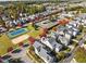 Aerial view of neighborhood homes and community amenities with a tennis court and swimming pool at 1400 Gathering Park Cir # 202, Cary, NC 27519