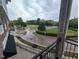 Exterior view from the balcony featuring a landscaped green space and neighborhood at 1400 Gathering Park Cir # 202, Cary, NC 27519