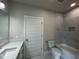 Bathroom with marble tiled shower, white cabinets, and modern fixtures at 1400 Gathering Park Cir # 202, Cary, NC 27519