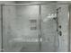 Luxurious bathroom features sleek glass shower, soaking tub, and marble wall tiles at 1400 Gathering Park Cir # 202, Cary, NC 27519